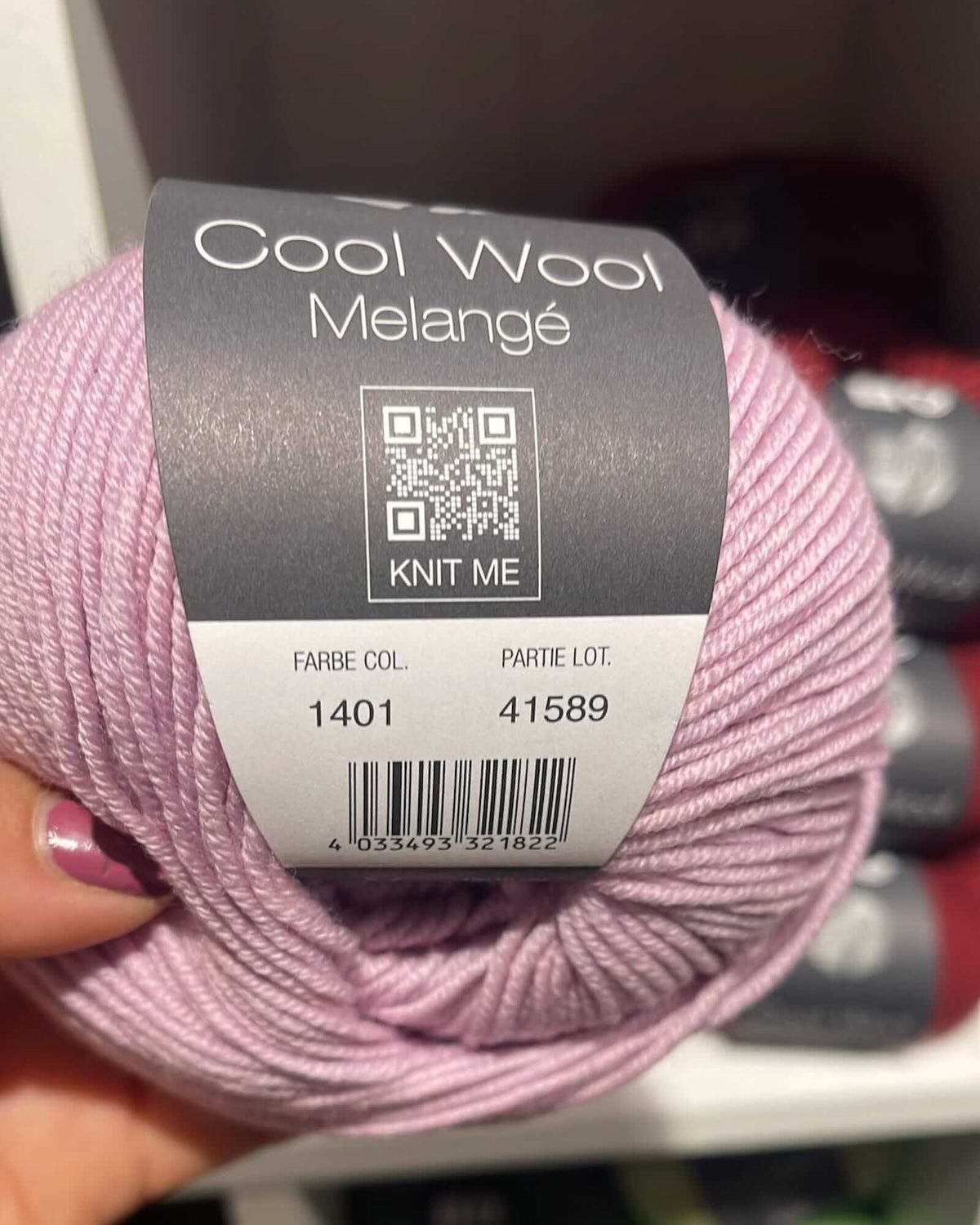 a wool yarn named "Cool Wool Melange", number 1401, of a lilac mottled color, from Lana Grossa brand